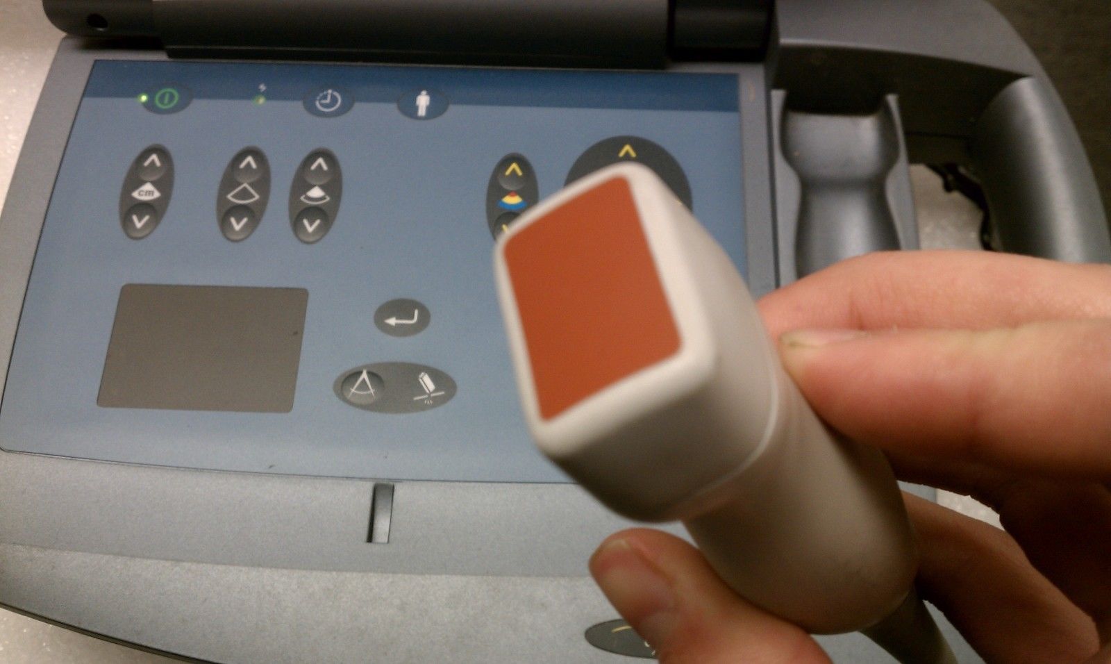 hand holding red probe 